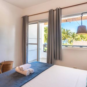 a view of the luxury king room looking out at the balcony at Kalipay Resort Siargao