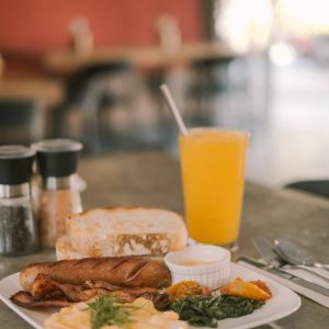 a plate of cooked breakfast including sausages, bacon and eggs in the Kalipay restaurant