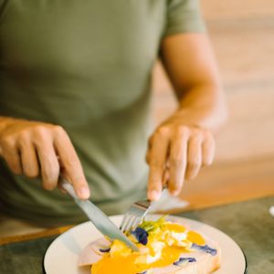 a woman eating some eggs benedict in the Kalipay restaurant