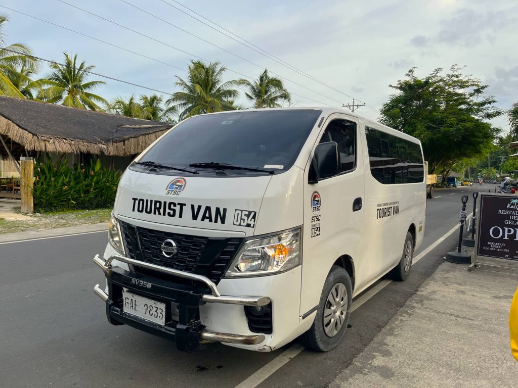 an airport tourist van parked outside Kalipay Resort Siargao