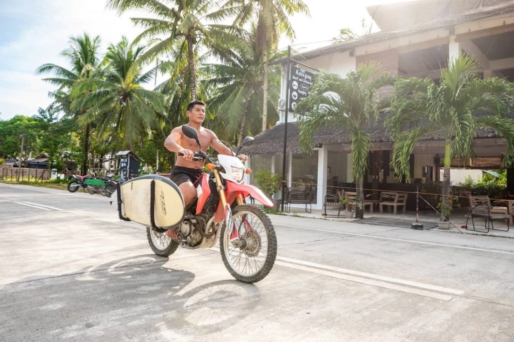 a man driving a motorbike outside Kalipay Resort Siargao