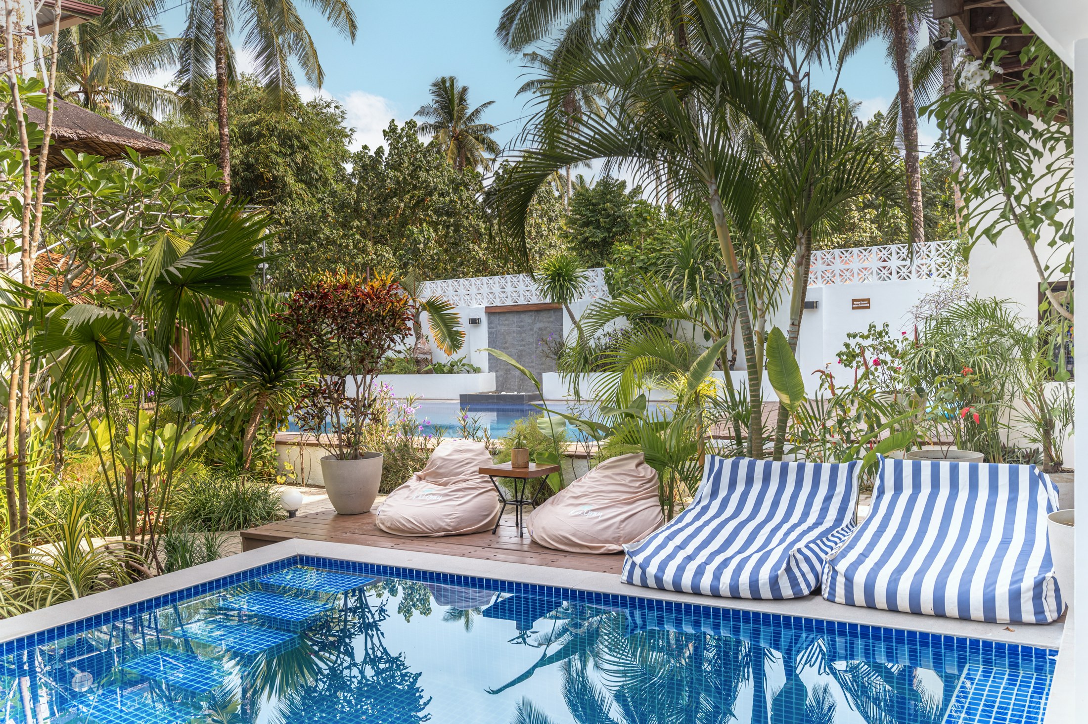 Kalipay’s two swimming pools with bean bags and tropical planting