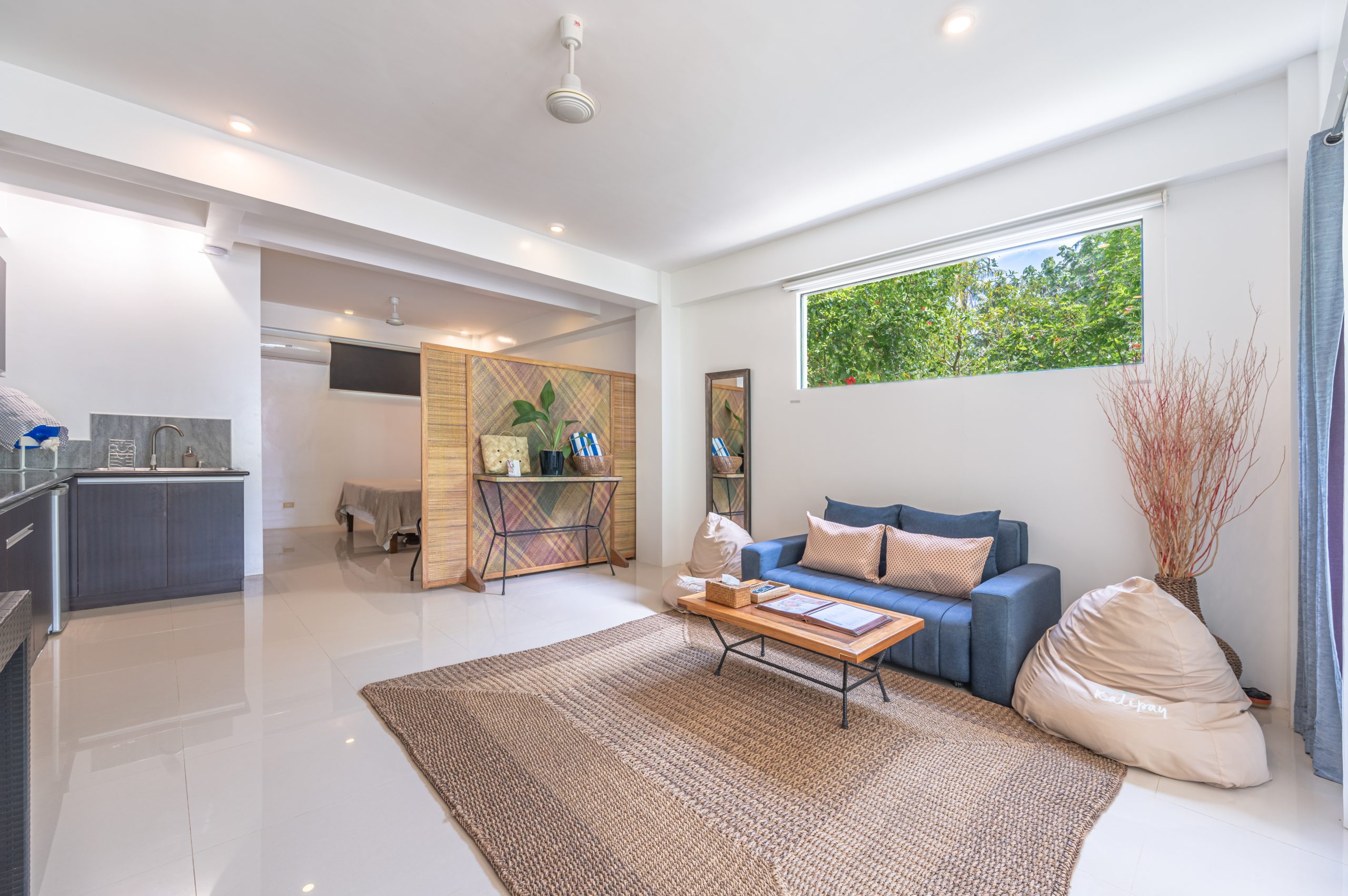 Studio living area with sofa seating and kitchenette