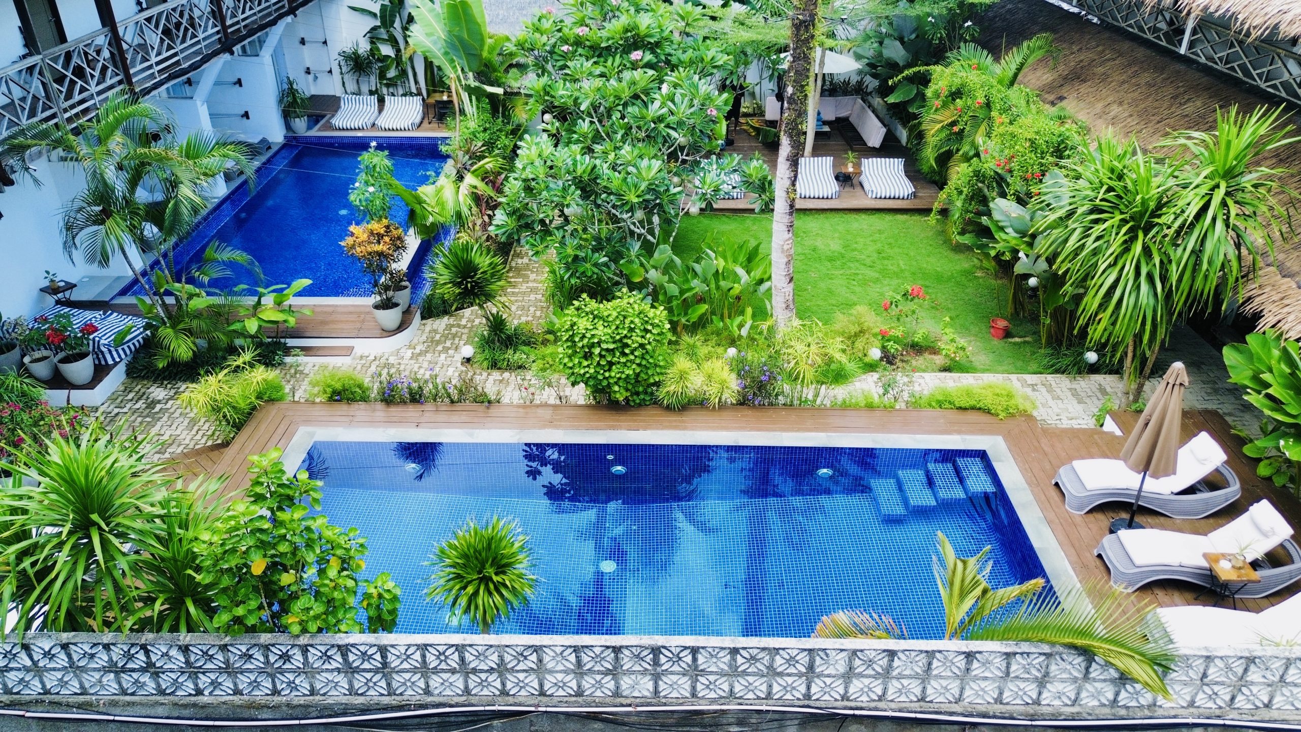 Aerial view of Kalipay Resort Siargao’s two swimming pools and tropical gardens