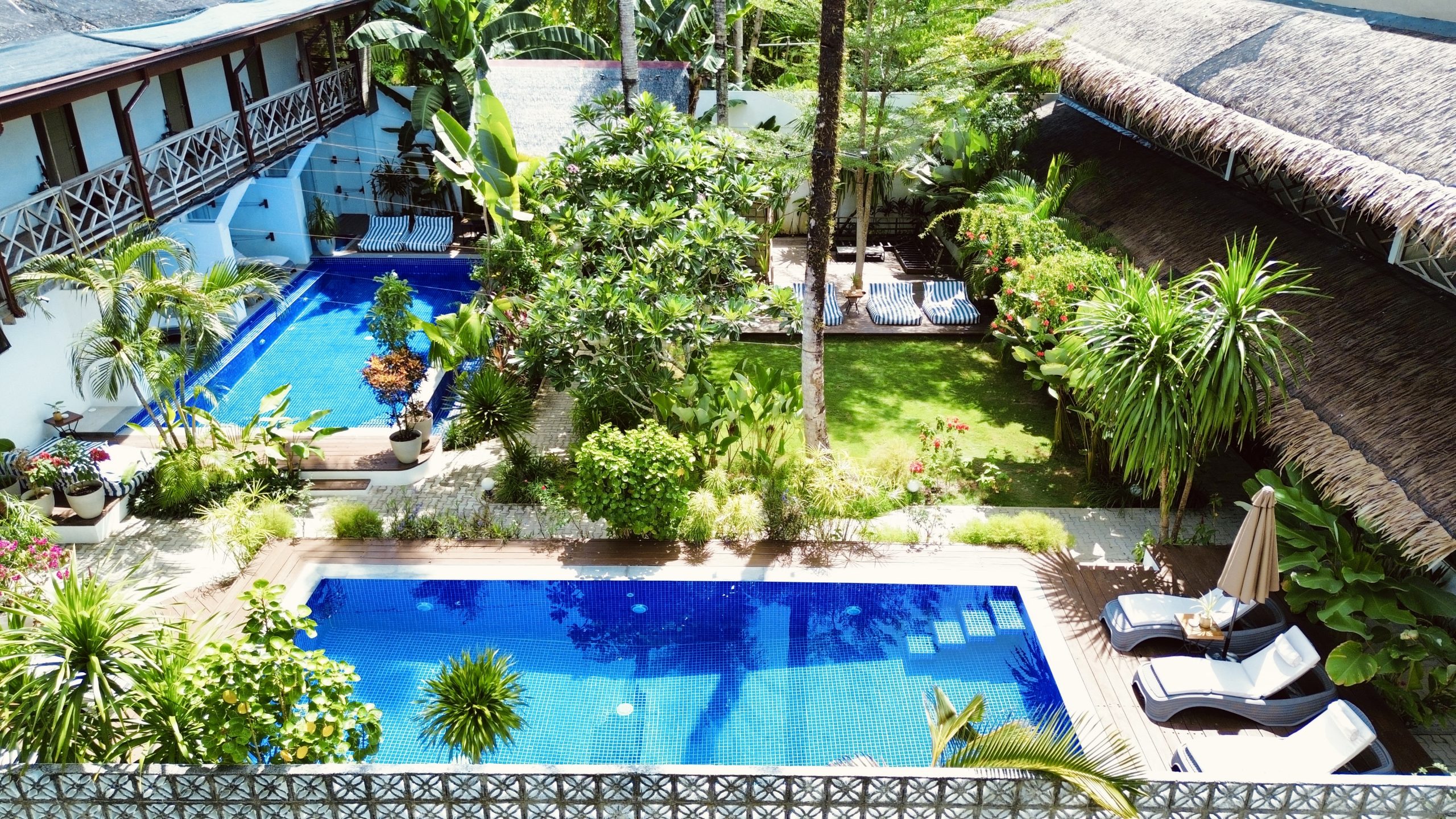 Aerial view of Kalipay Resort Siargao’s two swimming pools and tropical gardens